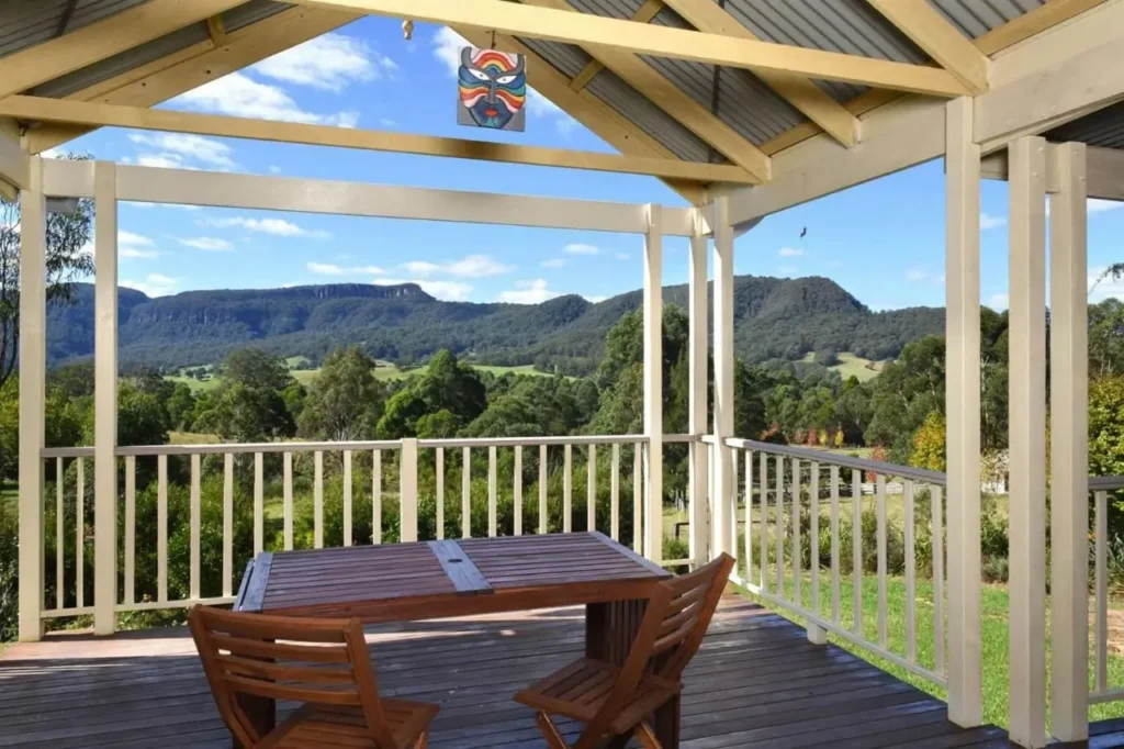 Wild Rose Kangaroo Valley featuring a luxury country estate with manicured gardens and elegant homestead style accommodation set against rolling green hills. The peaceful rural retreat offers a refined stay during a Kangaroo Valley family holiday.