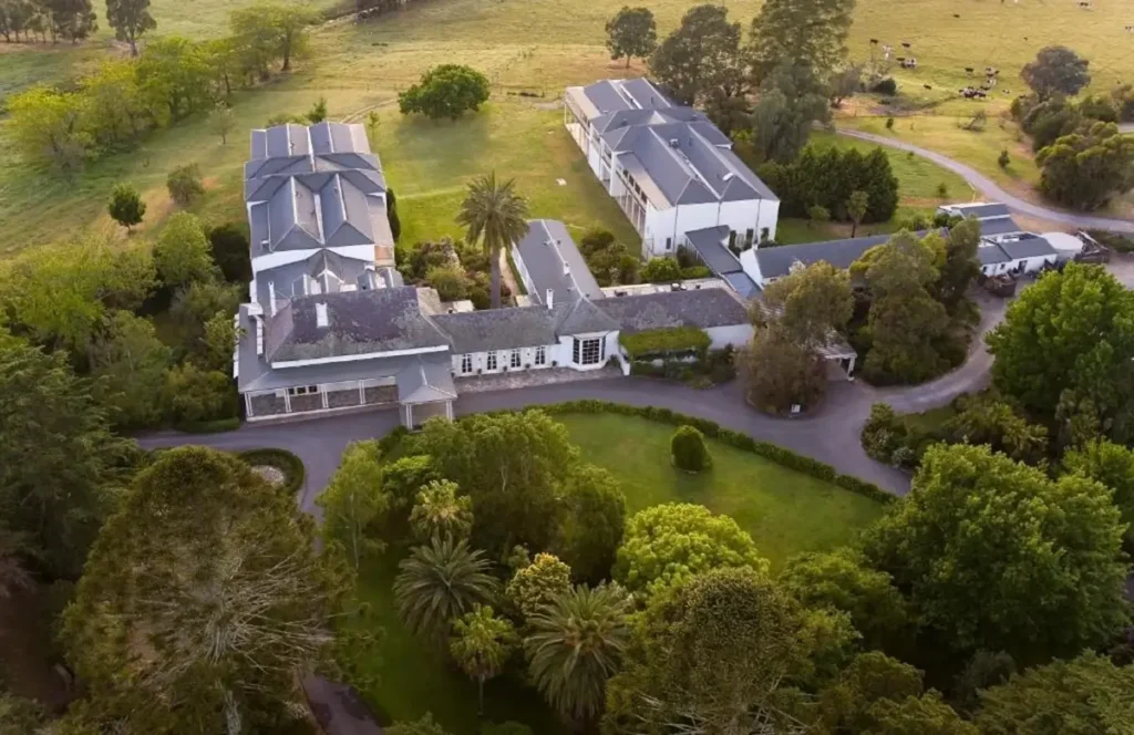 Aerial view of Chateau Yering Hotel surrounded by sweeping lawns, mature trees, and country roads in the Yarra Valley. The large estate and peaceful rural setting make it an inviting base for a Yarra Valley family holiday.