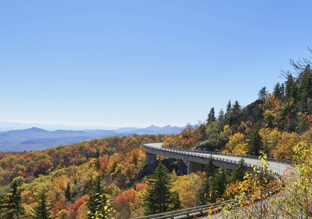 The Blue Ridge Parkway surrounded by vibrant autumn foliage in the Appalachian Highlands.