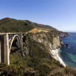 A scenic view of the Pacific Coast Highway with winding roads along the California coastline.