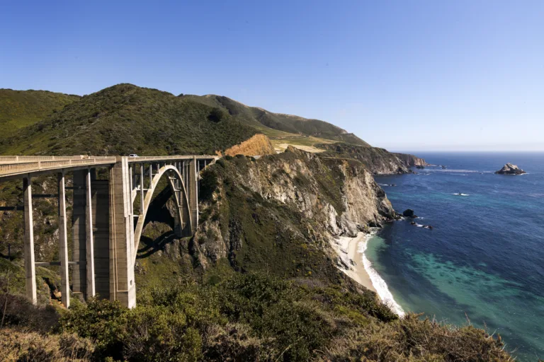 A scenic view of the Pacific Coast Highway with winding roads along the California coastline.