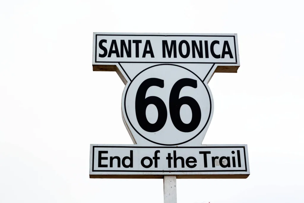 A historic Route 66 sign with a nostalgic feel against a desert backdrop.