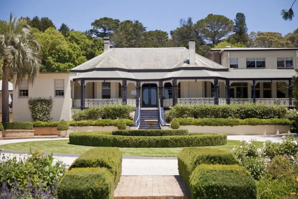 Peppers Craigieburn in Bowral featuring a grand heritage style manor with wide verandahs decorative iron lacework and manicured formal gardens. The elegant Southern Highlands retreat offers refined accommodation during a Bowral and Berrima family holiday.