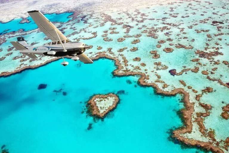 Heart Reef forms a natural heart shape in bright turquoise water near the Whitsundays. This scenic Great Barrier Reef landmark is a memorable stop on a Whitsunday Coast family holiday.