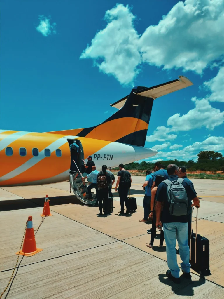 people boarding a plane using back steps