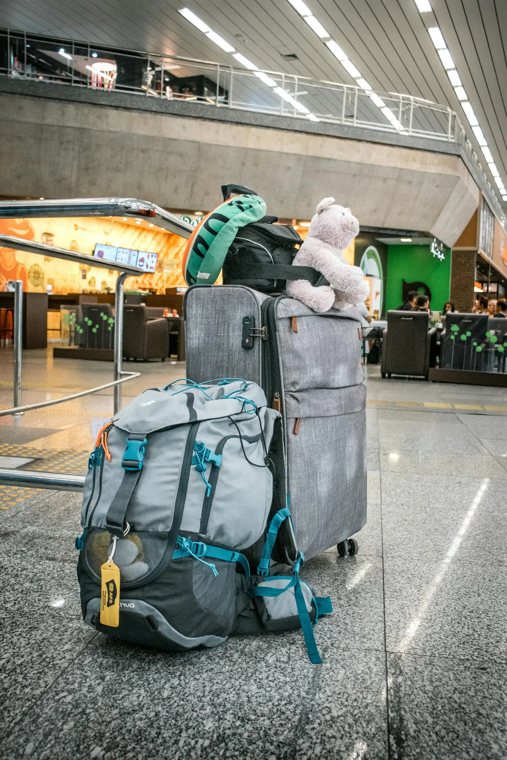 Teddy Bear Sitting atop Luggage Left in Airport