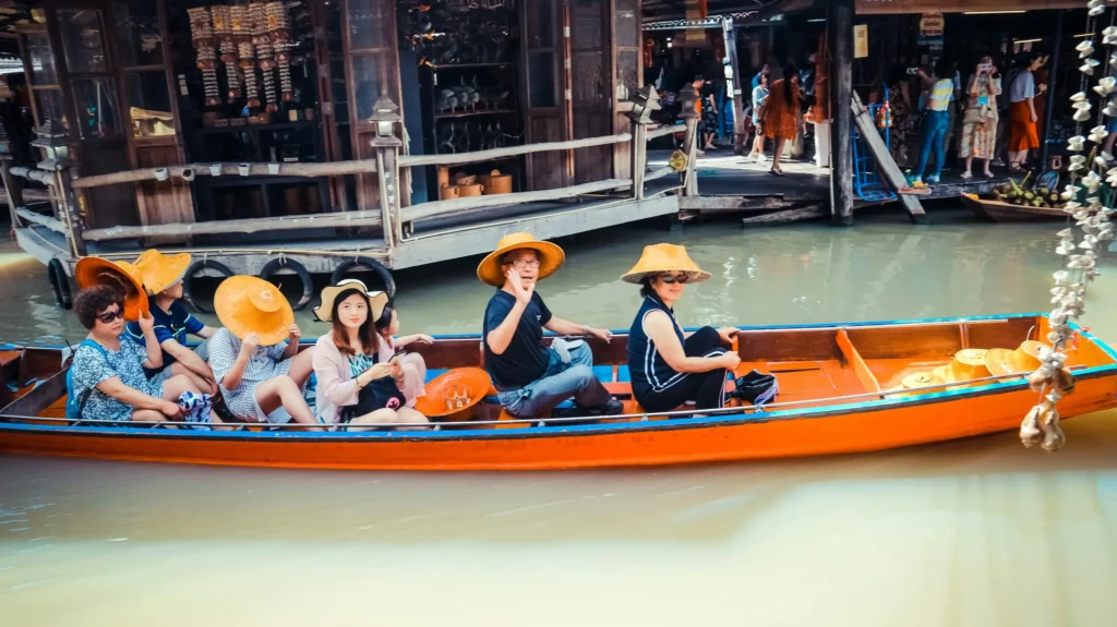 a-group-of-tourists-in-a-boat-at-a-vibrant-floating-market-in-thailand-exploring-local-culture
