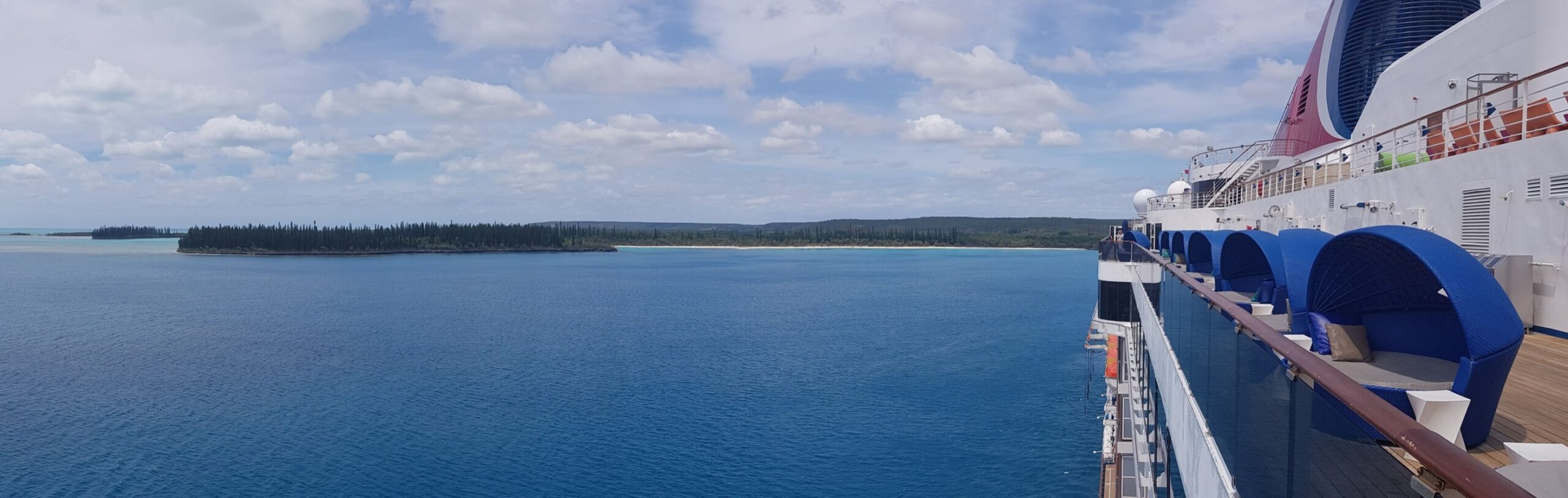 Carnival cruise ship deck overlooking a South Pacific island