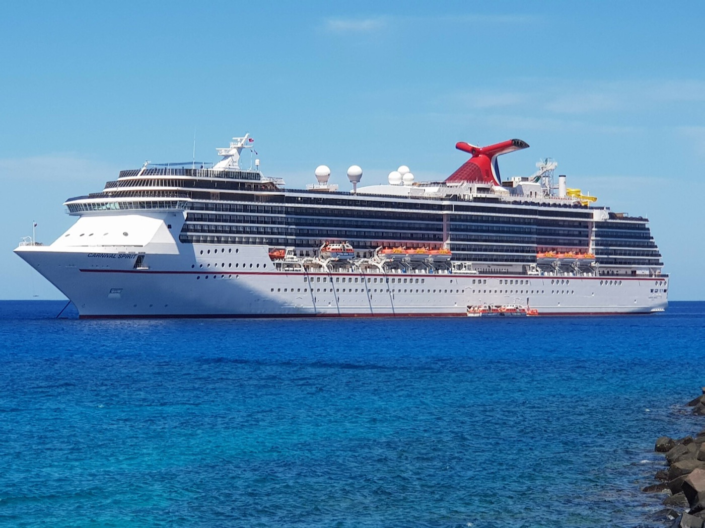 Carnival cruise ship at anchor on deep blue open water