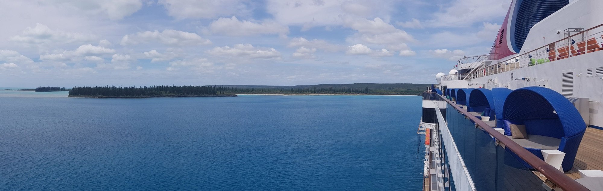 Carnival cruise ship deck overlooking a South Pacific island