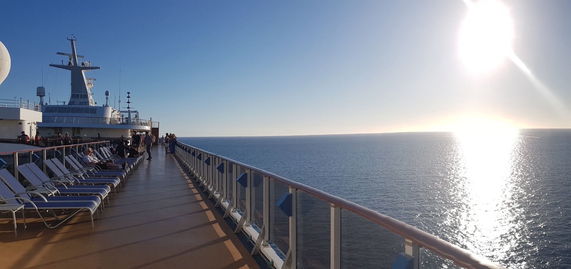 Sun deck loungers aboard a Carnival cruise ship at sea at sunset