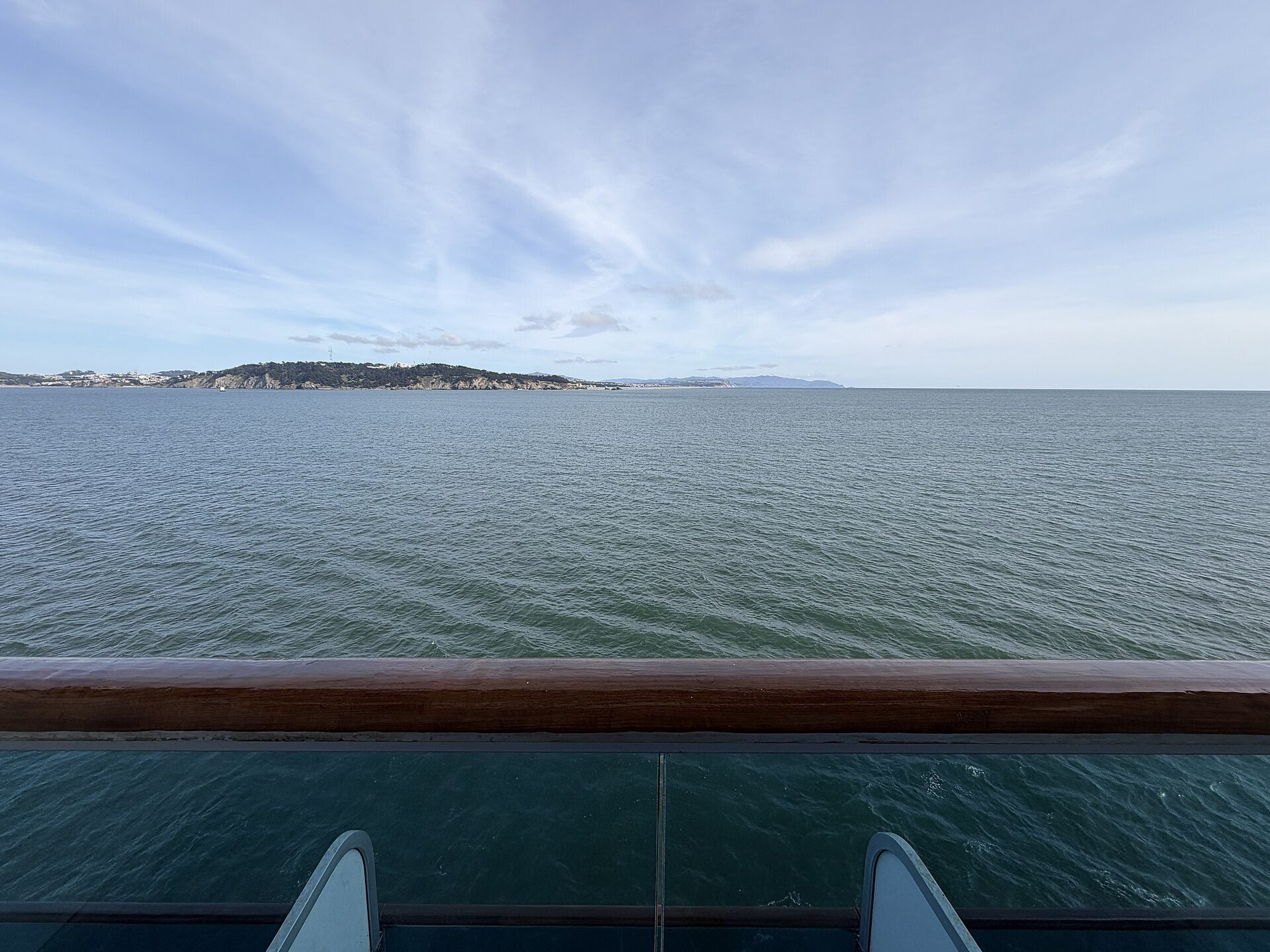 Cruise ship cabin with a porthole window looking out to sea