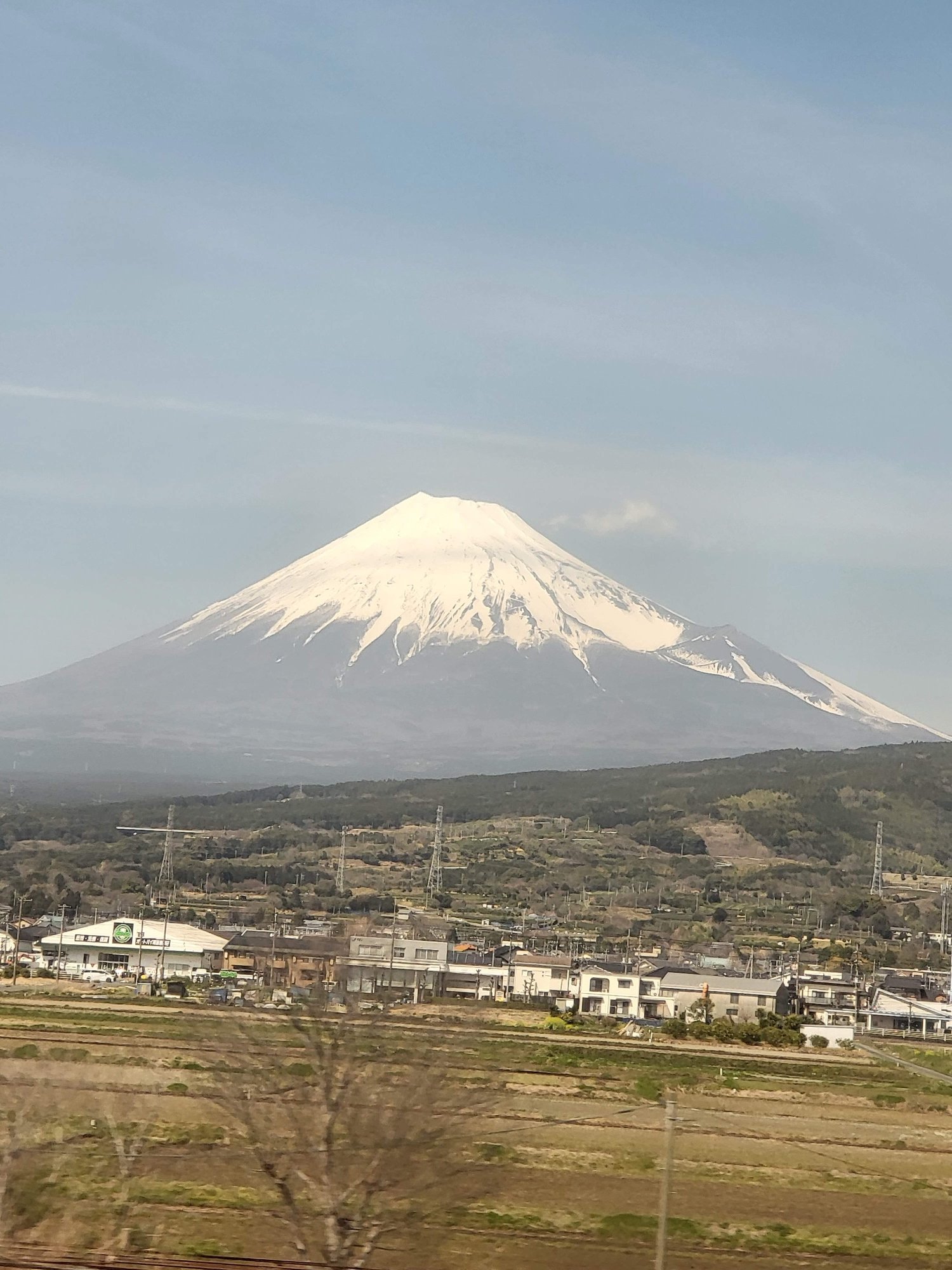 Snow-capped Mount Fuji rising above the town below