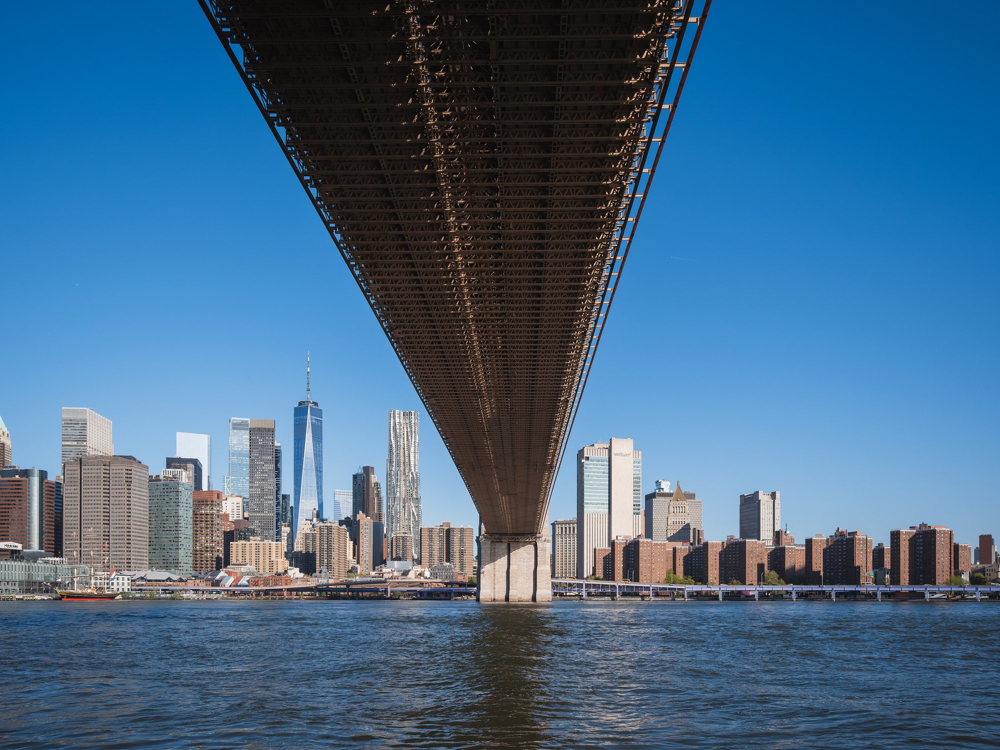 Brooklyn Bridge and the Manhattan skyline lit up at dusk, New York City